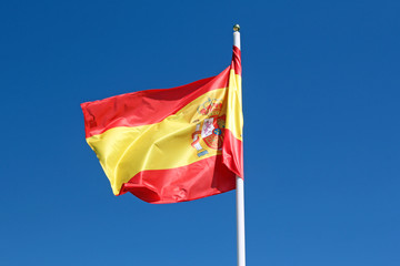 Fototapeta na wymiar spanish flag against blue sky