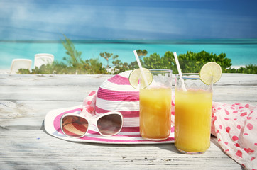 Sunglasses, hat and orange juice