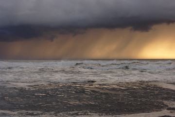 Sea storm at sunset