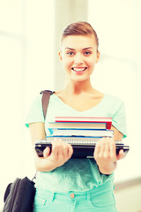 student with folders and school bag in college