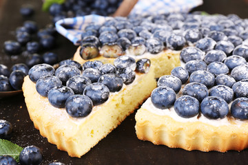 Tasty homemade pie with blueberries on wooden table