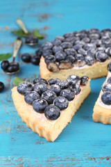 Tasty homemade pie with blueberries on wooden table