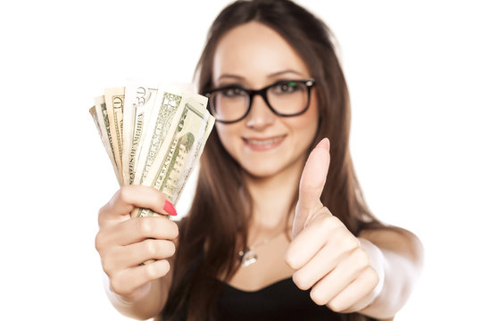 Woman Holding A Wad Of Cash In Hand And Showing Thumbs Up