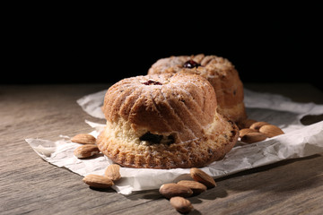 Tasty cakes on table on black background