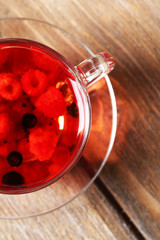 Fruit red tea with wild berries in glass cup,