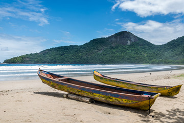 Fototapeta na wymiar Two beautiful rustic fishing boats at Dos Rios beach, Ilha Grand