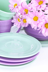 Bright dishes with flowers close up