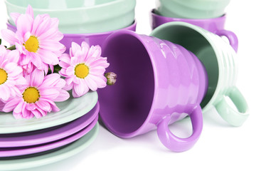 Obraz na płótnie Canvas Bright dishes with flowers close up