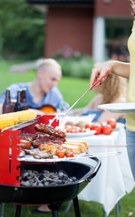 Woman serving grilled sausages