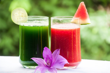 Fruit and vegetable juice on green bacckground