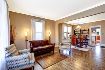 Living room interior with leather couch and two chairs.