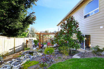 Fototapeta na wymiar Home garden with patio area and fireplace