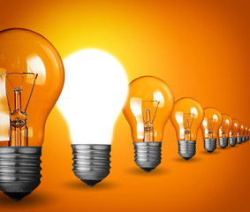 Idea concept with light bulbs on orange background