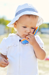 baby gir with toy phone