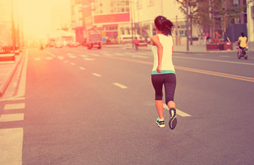  Runner athlete running on city road.  