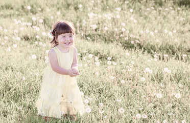 little girl with dandelions