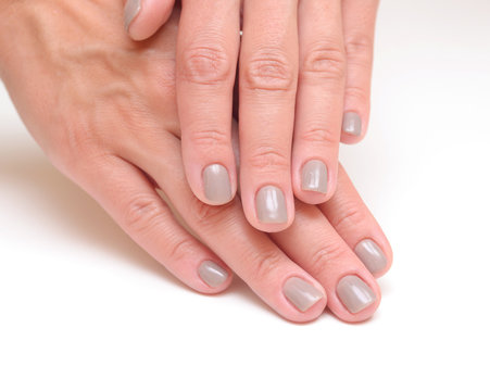 hands with woman's professional grey nails manicure isolated