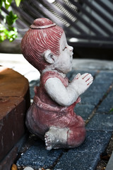 child statue in garden