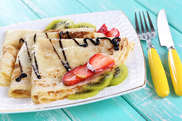 Delicious pancakes with strawberries and chocolate