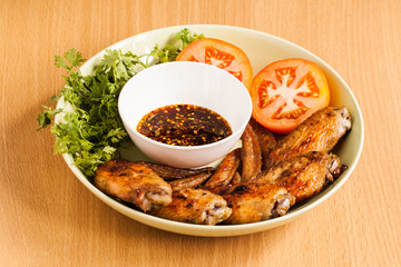 Grilled chicken wings on dish.