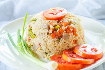 Fried rice with tomato on white plate
