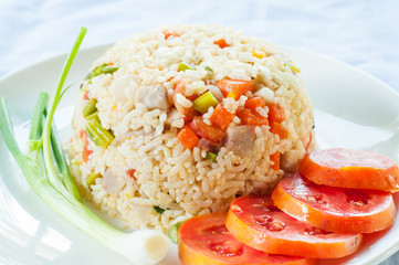 Fried rice with tomato on white plate