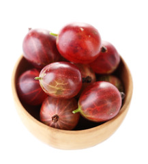 Ripe gooseberries in bowl isolated on white.