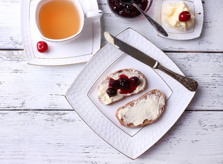 Fresh bread with cherry jam and homemade butter