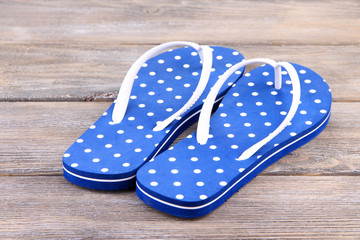 Color flip-flops on wooden background