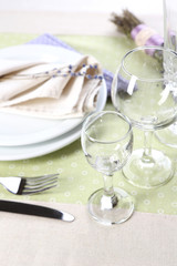 Dining table setting with lavender flowers on table background