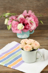 Bouquet of eustoma flowers and creamy roses on wooden