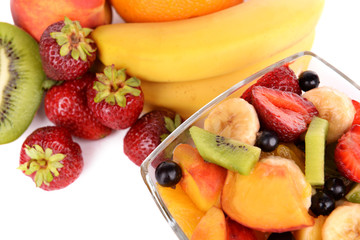 Fresh fruits salad in bowl with fruits and berries close up