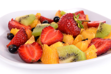 Fresh fruits salad on plate close up