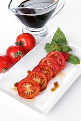 Balsamic vinegar,  tomato and basil isolated on white