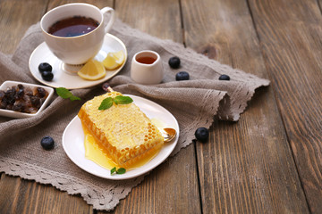 Healthy snack with fresh honey on wooden table