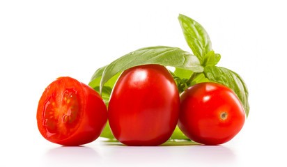 fresh tomatoes with green leaves isolated on white background