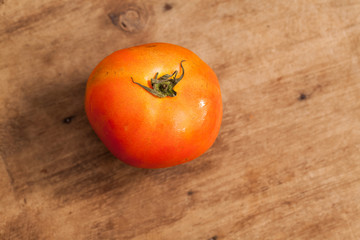 Tomato on the wood background.
