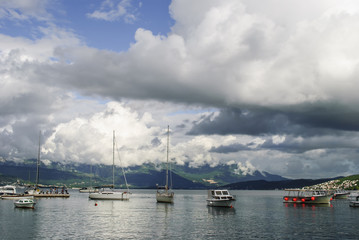 Fototapeta na wymiar Cloudy Day over a small marina in the Bay of Kotor