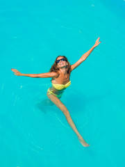 A girl is relaxing in a swimming pool