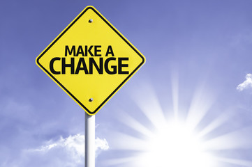 Make a Change road sign with sun background