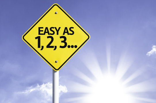 Easy as 1, 2, 3 road sign with sun background