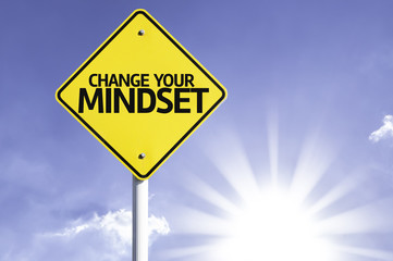 Change your Mindset road sign with sun background