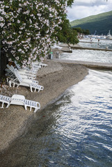 Fototapeta premium Deckchairs on small beach