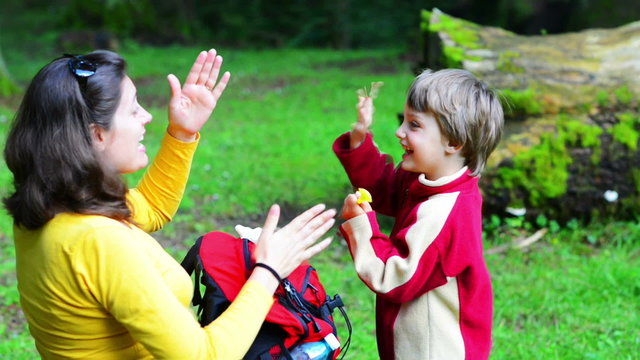 Mother And Son Singing In The Forest