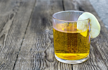 juice glass with an apple segment