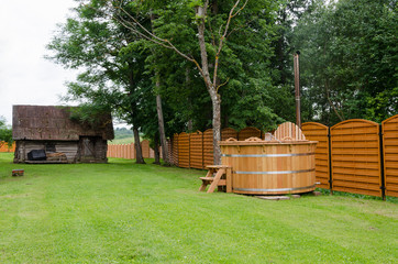 wooden hot tub water rural yard. outdoor pleasure.