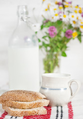 Fresh milk in old fashioned bottle and homemade bread