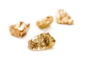 Gold nuggets on white background.