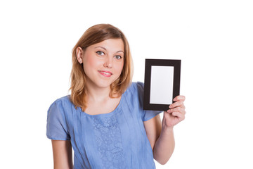 Fototapeta premium Portrait of a cheerful young brunette woman holding a white blan