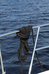 Nautical rope attached around a boat handrail